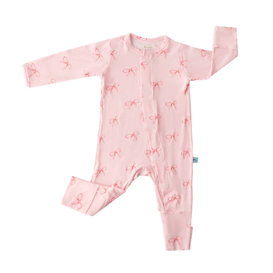 Pink baby romper with bow pattern on a white background