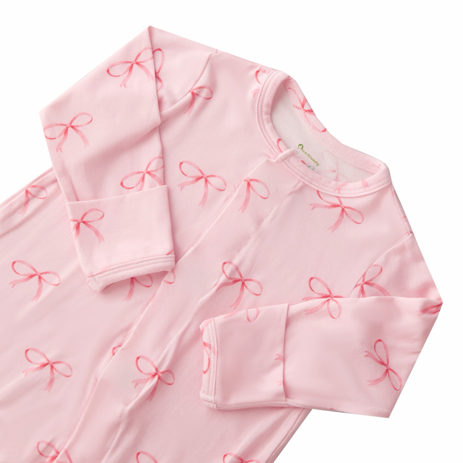 Pink baby outfit with red bows on a white background