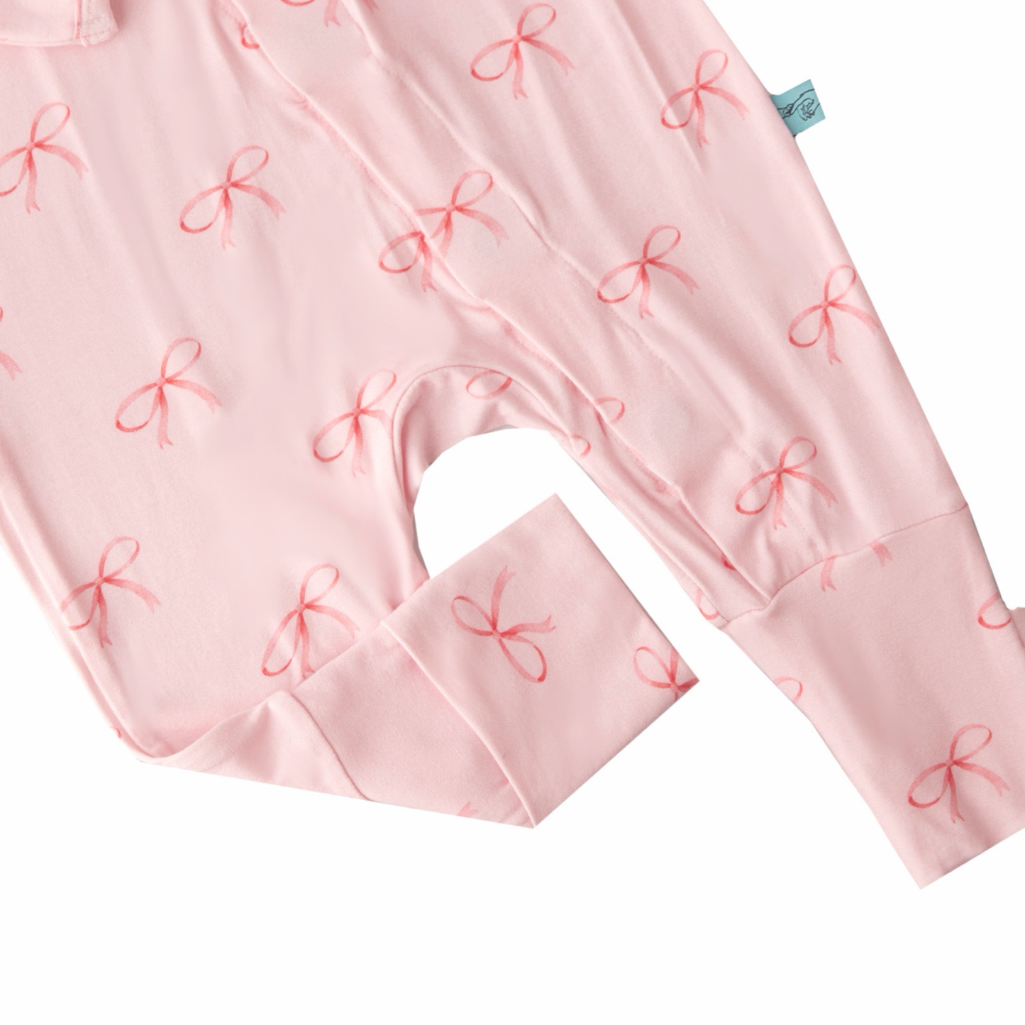 Pink baby outfit with bow pattern on a white background